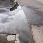 Drainage Issue on Road at 1901–1937 Centre Ave E