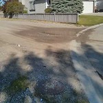 Drainage Issue on Road at 15150 Mc Kenzie Lake Blvd SE Calgary, Ab T2 Z 2 L4